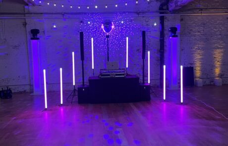 Event venue with a dj booth and led lighting setup ready for a party.