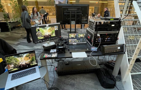 Professional video production setup with multiple monitors and equipment in an indoor location.